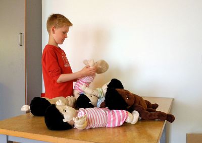 Óli Gunnar Sveinarsson plays with dolls at the Hjalli elementary school in Reykjavik, Iceland.