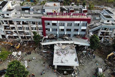 French members of the International Emergency Firefighters and locals search for survivors in the badly damaged Mercure hotel in Palu, Indonesia on Oct. 4, 2018.