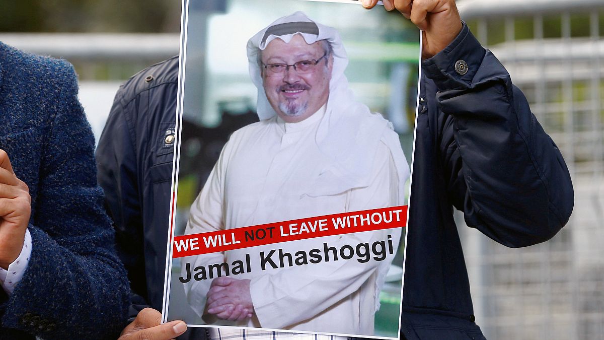 Image: A demonstrator holds picture of Saudi journalist Jamal Khashoggi dur