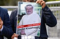 Image: A demonstrator holds picture of Saudi journalist Jamal Khashoggi dur