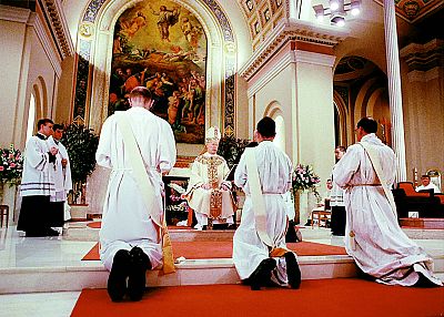 Newly ordained priests, including Christopher Clay, center, kneel before Bishop James Timlin at St. Peter\'s Cathedral in Scranton, Pennsylvania, in June 1998.