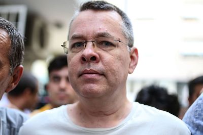 Pastor Andrew Craig Brunson is escorted by Turkish plainclothes police officers to his house on in Izmir on July 25, 2018.