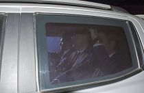 Image: Andrew Brunson, center, sits inside a car as he arrives for his tria