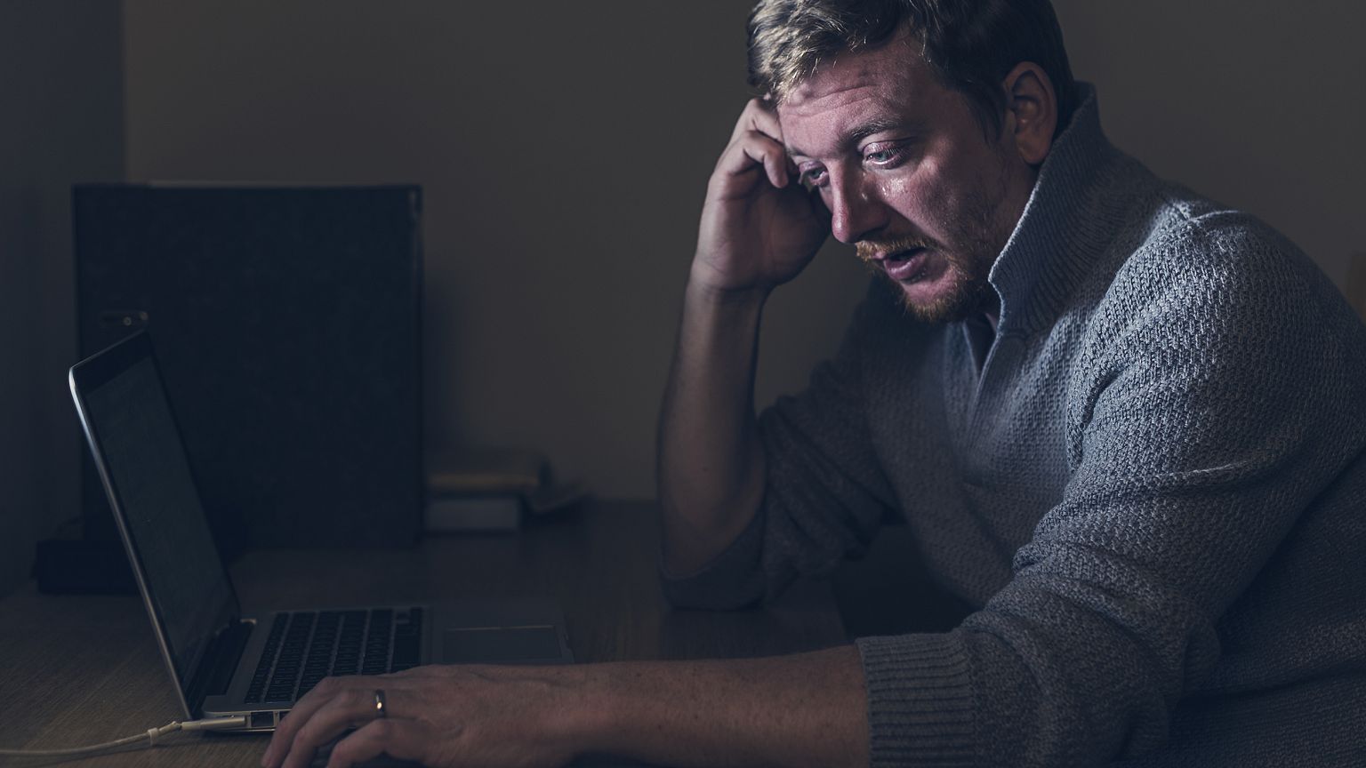 Image: Sad Man at Home Desk
