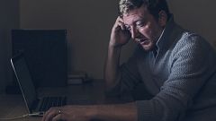 Image: Sad Man at Home Desk