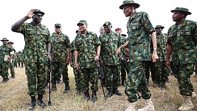[Photos] Buhari swaps 'Agbada' for full military outfit as he visits troops