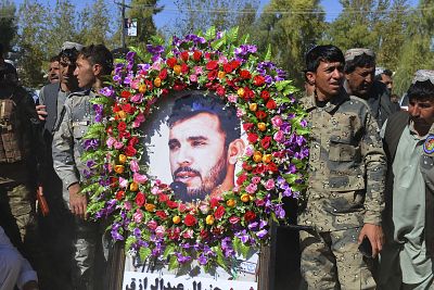 Military personnel hold a photo of Gen. Abdul Raziq, Kandahar police chief during his burial ceremony on Friday. Raziq\'s death deals a powerful blow to the Afghan government\'s already flagging war against a resurgent Taliban.