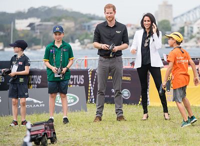 Prince Harry and Meghan, Duchess of Sussex, had a blast Saturday playing with remote controlled cars at the Jaguar Land Rover Driving Challenge at the Invictus Games in Sydney.