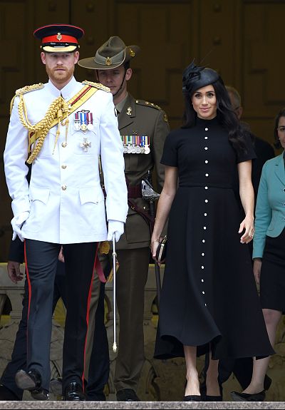 Prince Harry looked dashing in official military uniform, while the duchess donned an elegant black dress at the Anzac Memorial in Hyde Park, Sydney.