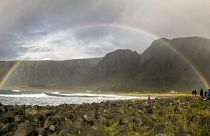 Image: Wintry rain brings a splash of color to the beach in the Lofoten isl