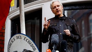 Image:  WikiLeaks founder Julian Assange speaks on the balcony of the Ecuad
