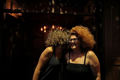 Women talk to each other in a bar in the Old City of Damascus on Sept. 13.