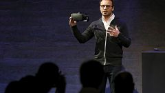 Oculus CEO Brendan Iribe displays a virtual reality headset during an event