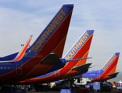 Southwest Airlines jets wait on the tarmac.