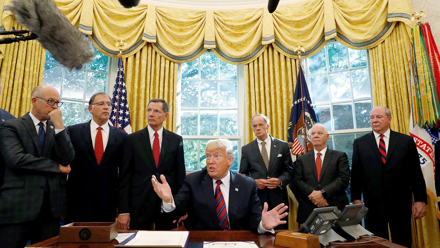 Image: U.S. President Trump talks to reporters during bill signing ceremony