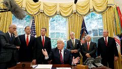 Image: U.S. President Trump talks to reporters during bill signing ceremony
