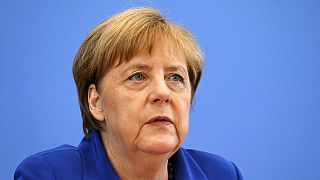 Angela Merkel stands by refugee policy after attacks in Germany