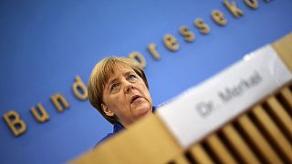 Angela Merkel stands by refugee policy after attacks in Germany