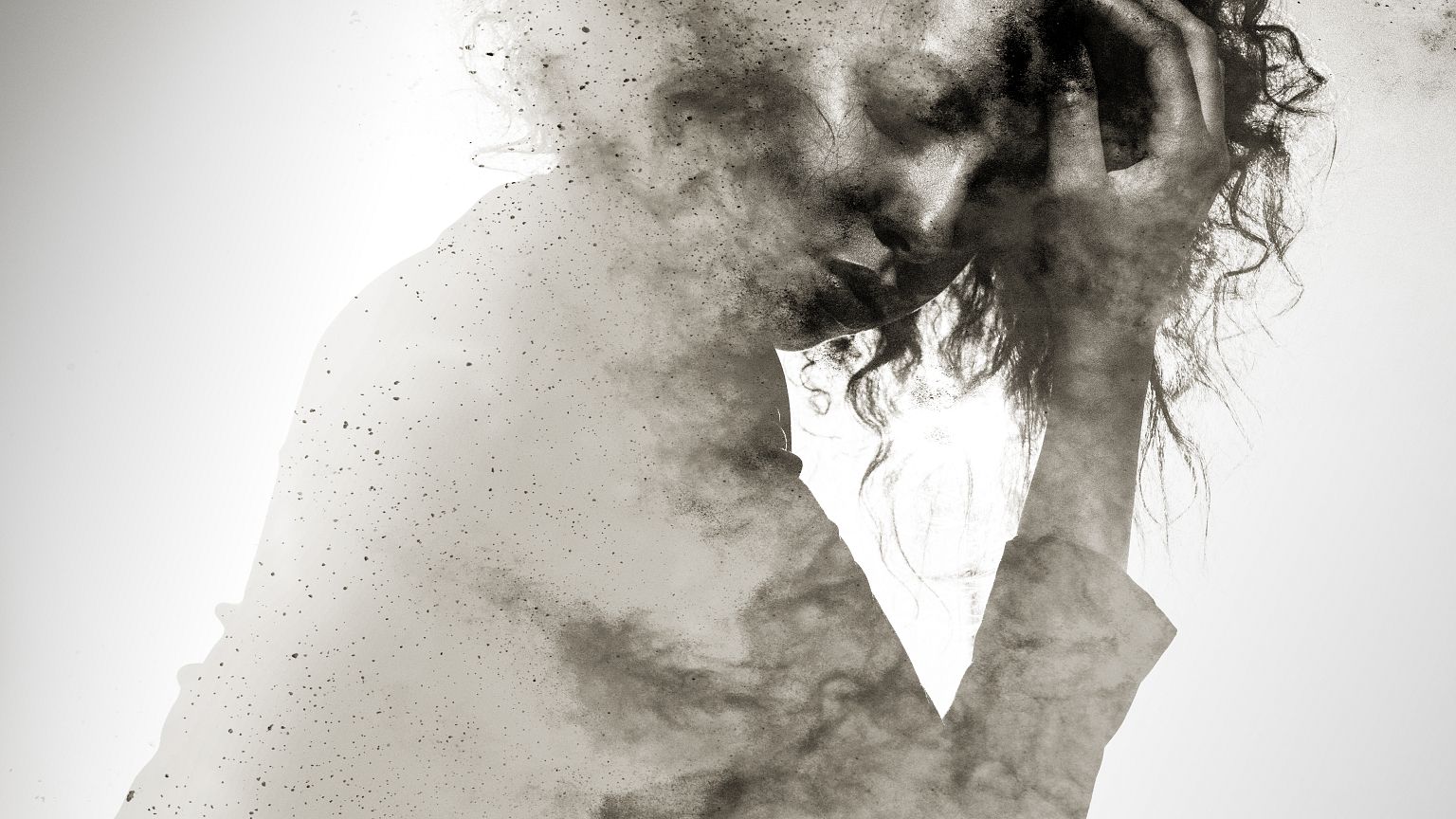 Unhappy woman's form double exposed with paint splatter effect