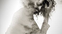 Unhappy woman's form double exposed with paint splatter effect