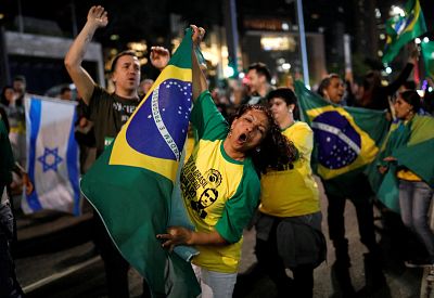 Supporters of Jair Bolsonaro, a far-right lawmaker who was elected president of Brazil on Sunday, react after polls closed in Sao Paulo, Brazil. 