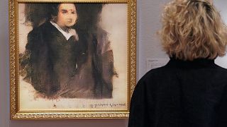 Image: A woman looks at a work of art created by an algorithm by French col
