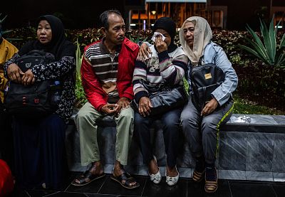 Relatives wait for news at a crisis center in Jakarta.