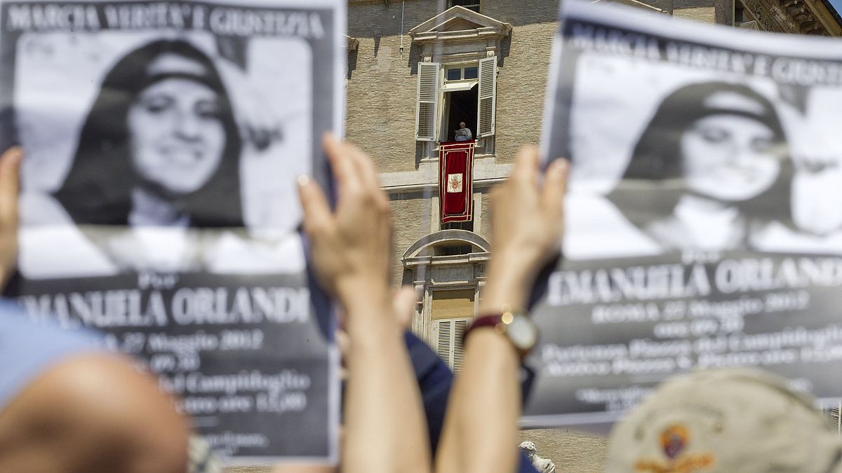 Image: Demonstrators hold pictures of Emanuela Orlandi, as Pope Benedict XV