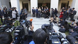 Image: Oh Seung-hun, top center, speaks to the media after the verdict