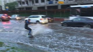 Surfer à travers les rues de Moscou inondées