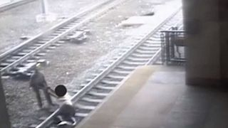 Police officer saves man from train tracks in dramatic near-miss
