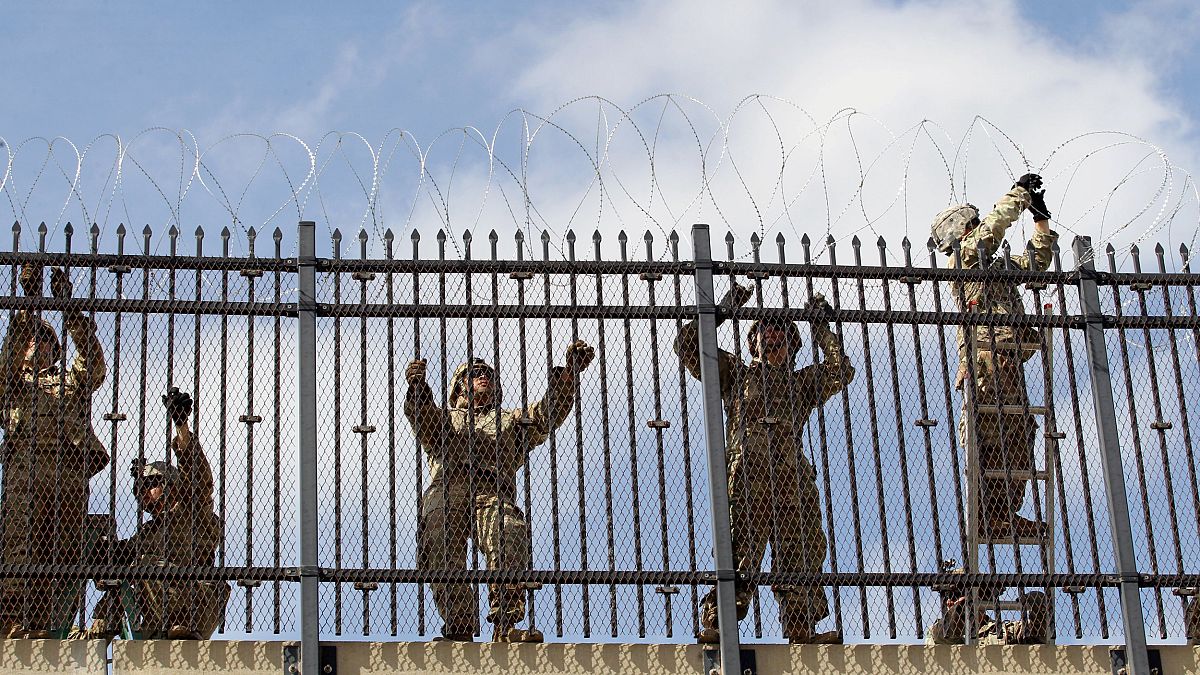 Image: FILE PHOTO: FILE PHOTO: U.S. Army soldiers install a razor wire fenc