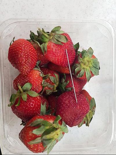 A thin piece of metal seen among a punnet of strawberries, in Gladstone, Australia.