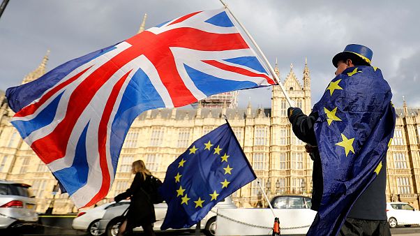 Image: An anti-Brexit demonstrator waves a Union flag alongside a European Image: An anti-Brexit demonstrator waves a Union flag alongside a European