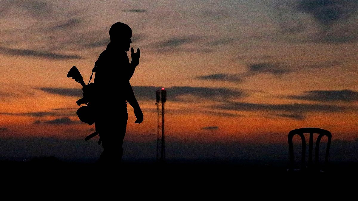 Image: The silhouette of an Israeli soldier is pictured in the southern Isr