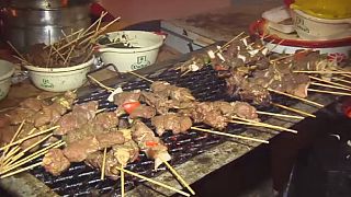 Ivorians enjoying grilled food during festival