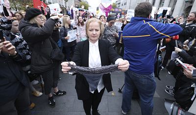 Irish lawmaker Ruth Coppinger holds a thong during a protest in Dublin.