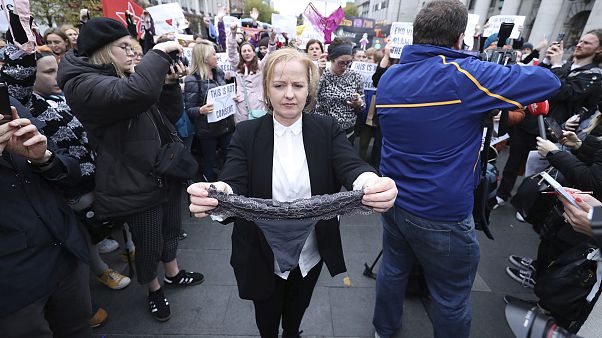Image: Irish lawmaker Ruth Coppinger holds a thong during a protest Image: Irish lawmaker Ruth Coppinger holds a thong during a protest