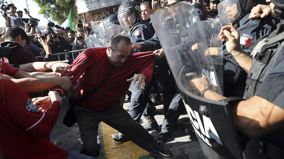 Demonstrators clash with police outside a migrant shelter as they protest t