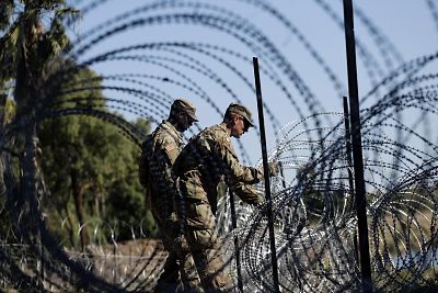 Members of the U.S. military install multiple tiers of concertina wire along the banks of the Rio Grande near the Juarez-Lincoln Bridge at the U.S.-Mexico border in Laredo, Texas on Nov. 16, 2018.