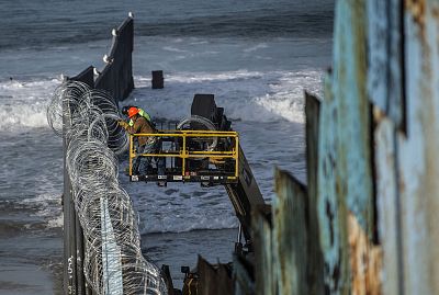Workers reinforce the security on the US side of the border fence with Mexico, as seen from Playas de Tijuana, Mexico, on November 15, 2018.