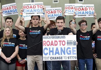 Cameron Kasky, center, speaks at a news conference on June 4, 2018, in Parkland, Florida, where a group of school shooting survivors announced a multi-state bus tour to "get young people educated, registered and motivated to vote."