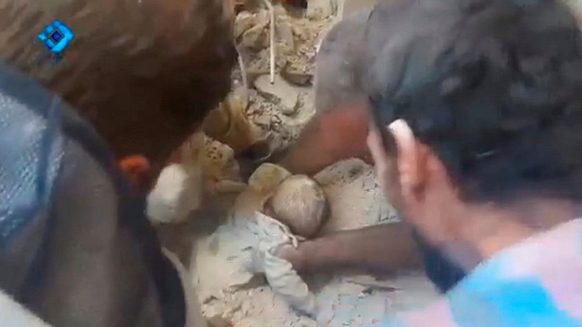 Toddler and a little girl rescued from rubble in Aleppo