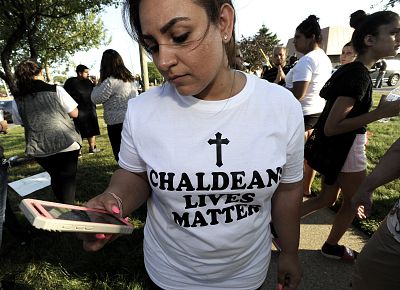 Astevana Shaya, 28, of Sterling Heights, Mich., wears a Chaldeans Lives Matter T-shirt at a protest on June 12, 2017 in Sterling Heights, Michigan. The arrests of dozens of Iraqi Christians in southeastern Michigan by U.S. immigration officials appear to be among the first roundups of people from Iraq who have long faced deportation, underscoring rising concerns in other immigrant communities.