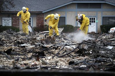 Search and rescue crews dig through the burnt remains of a business in Paradise, California on November 21, 2018.