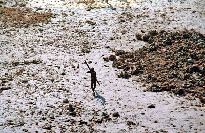 A tribesman aims his bow at an Indian coast guard helicopter as it flew over North Sentinel Island in 2004.