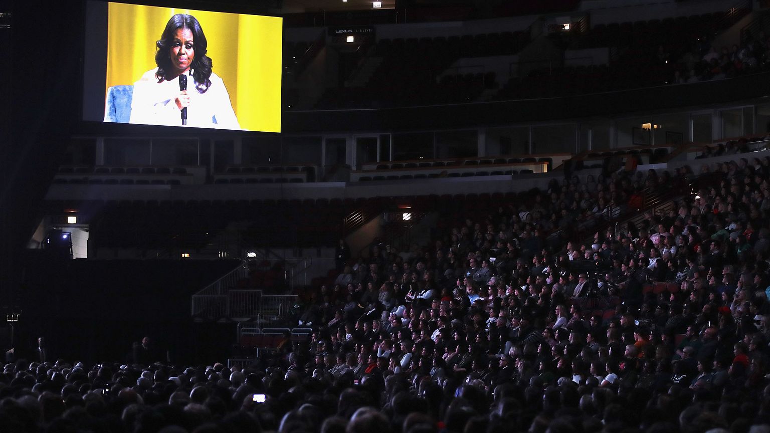 Image: Guests watch as Oprah Winfrey interviews former first lady Michelle 