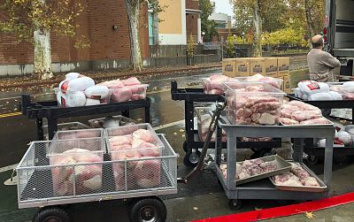 Hundreds of frozen turkeys are unloaded on the campus of California State University in Chico, Calif. on Nov. 21, 2018.