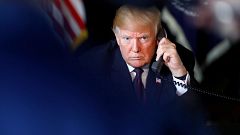 Image: U.S. President Donald Trump speaks via video teleconference with tro