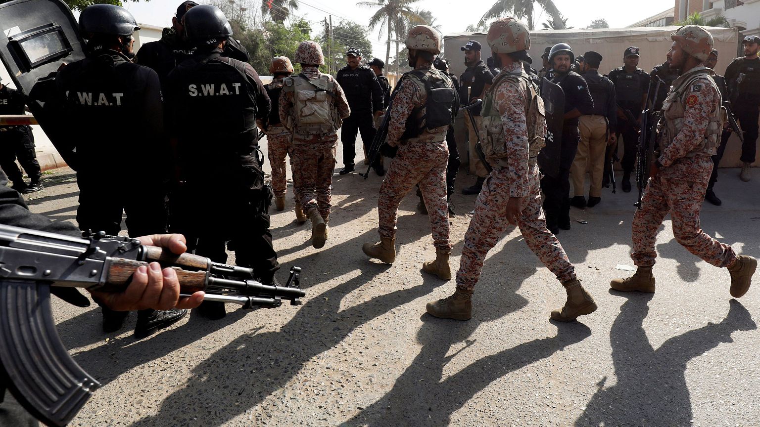 Image: Paramilitary soldiers walk after an attack on the Chinese consulate,